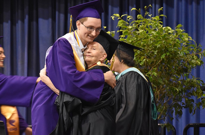Sarasota County School Board Chairwoman Caroline Zucker embraces a graduate after awarding him his diploma during the Booker High School Graduation on June 3 at Robarts Arena.