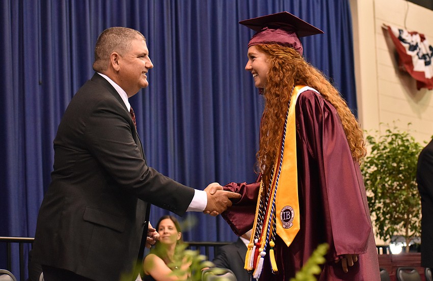 Superintendent of Sarasota County Schools Dr. Todd Bowden shakes hands with Sydney Verman before receiving her diploma during the Riverview High School Commencement Ceremony on June 3 at Robarts Arena.