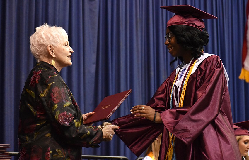 Sarasota County School Board Chairwoman Caroline Zucker awards Joanne Gustave with her diploma during the Riverview High School Commencement Ceremony on June 3 at Robarts Arena.