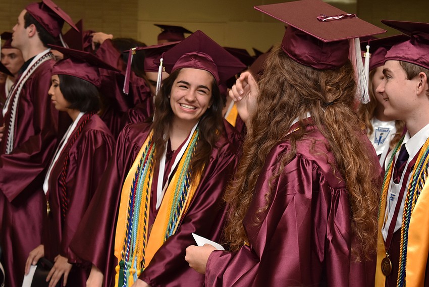 Students laugh before getting in line for the processional during the Riverview High School Commencement Ceremony on June 3 at Robarts Arena.