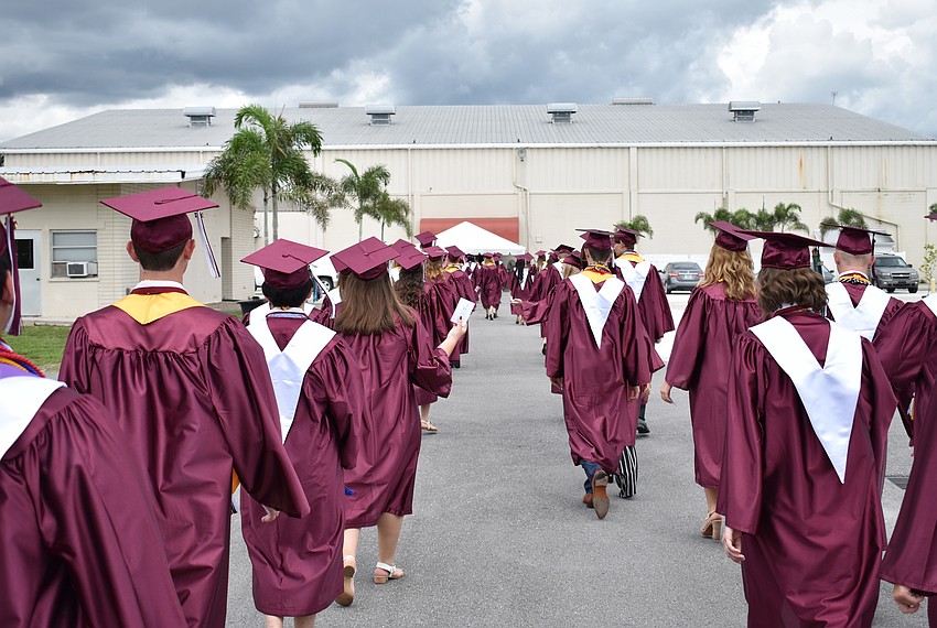 Students walk to the arena in line for the processional during the Riverview High School Commencement Ceremony on June 3 at Robarts Arena.