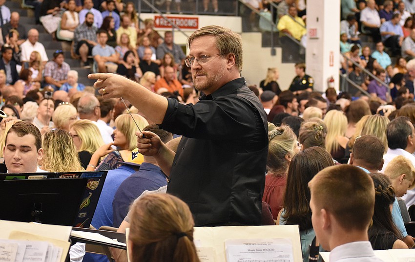 Norm Vagn, director of the RHS Orchestra, conducts the Riverview High School Wind Ensemble during the Riverview High School Commencement Ceremony on June 3 at Robarts Arena.