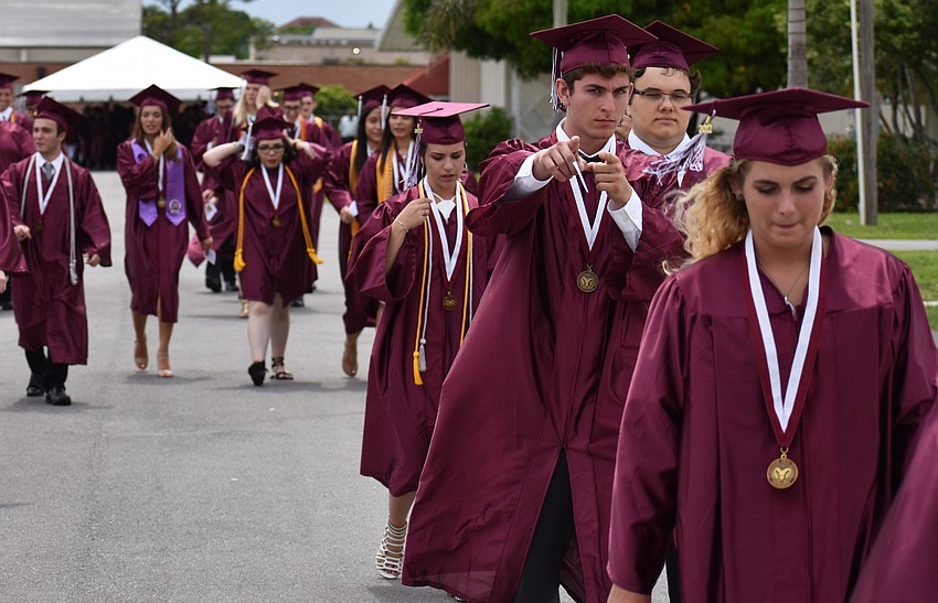 Students walk to the arena in line for the processional during the Riverview High School Commencement Ceremony on June 3 at Robarts Arena.