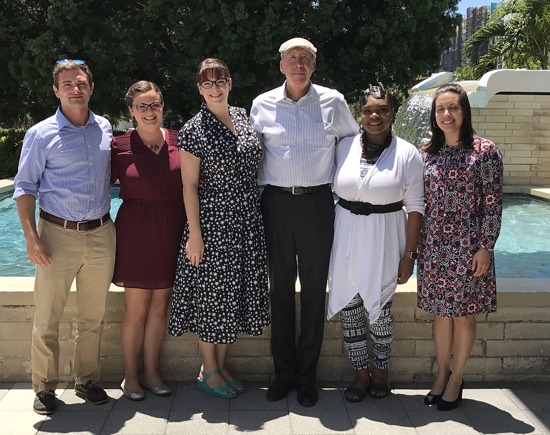 Jeff Kattrein, Jamie Minton, Young Professionals Group Coordinator Mimi Cirbusova, City Manager Tom Barwin and Shantel Norman and Hellen Osorio pose outside City Hall after a meeting in May.