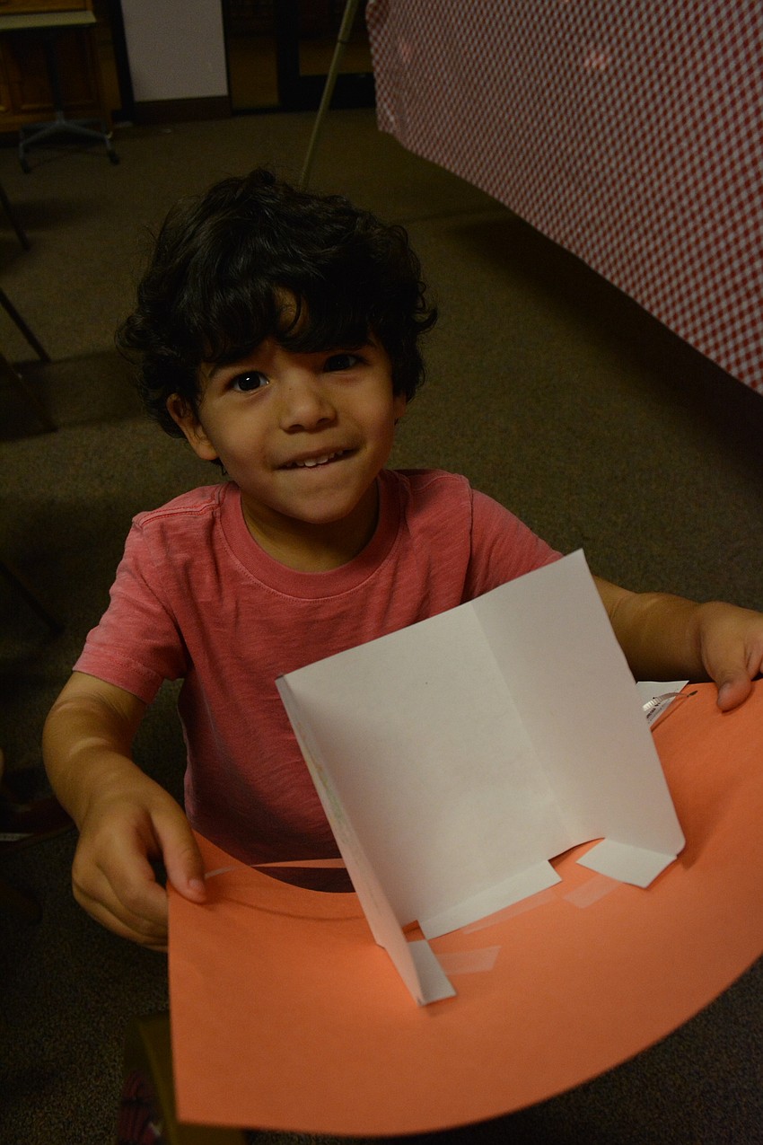 Josh Oleaga, 5, shows off his Wall of Jericho craft.
