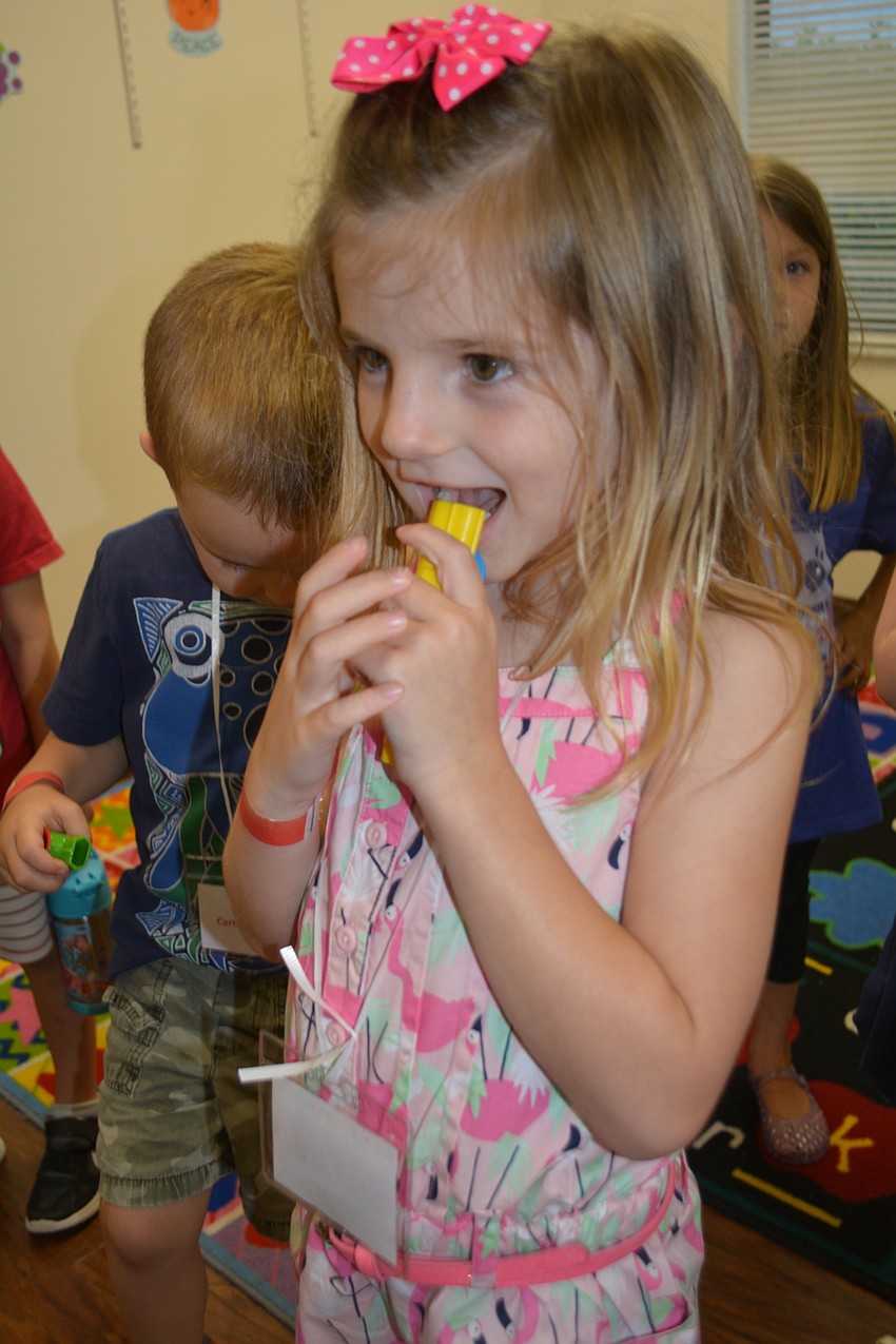 Adriana Buchanan tests out her kazoo, which she used to blow down an imaginary Wall of Jericho.