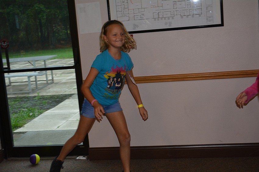 Natalie Magrin, 9, plays speed ball, a game in which a person is out if the ball hits the ground after she touches it.