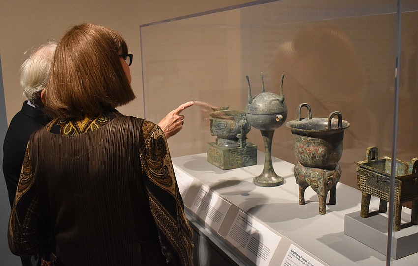 Martin Tucker and Bernice Davis admire some Chinese food vessels from the 11th C BCE at the Eternal Offerings: Chinese Ritual Bronzes exhibit on June 7 at The Ringling.