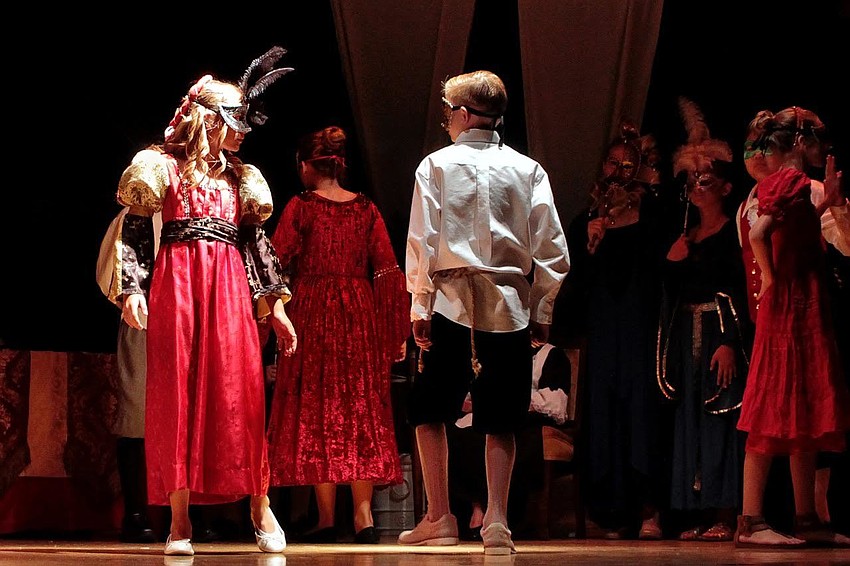 Juliet (Liza Strong) and Romeo (Will Hall) see each other for the first time.