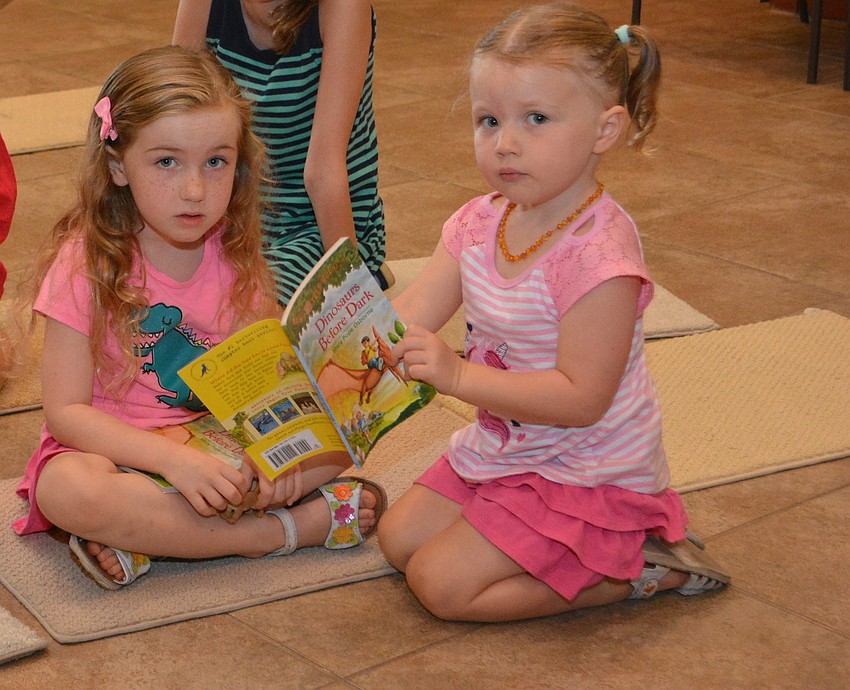 Mya, 5, and Ayla, 2, Kroot of Bradenton check out a book before the STAR series event began at the Sarasota Polo Club.