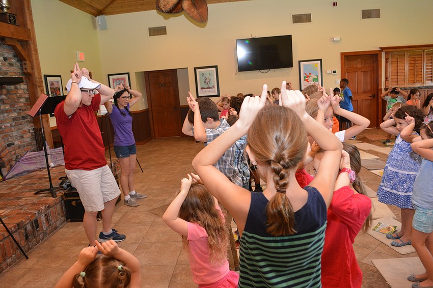 Logan Junkins and Eliza Engle lead children through some imagination exercises before they began the show.