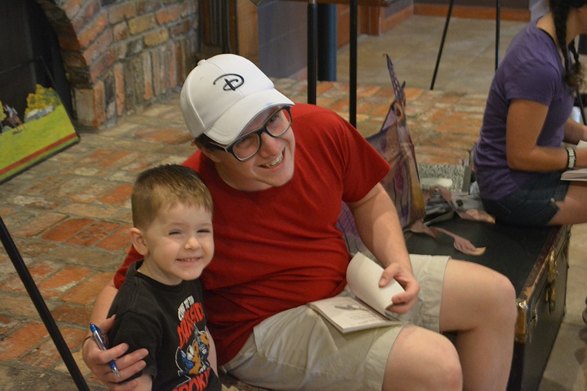 Ryder Stewart, 3, of Apollo Beach, gets an autograph from Logan Junkins.