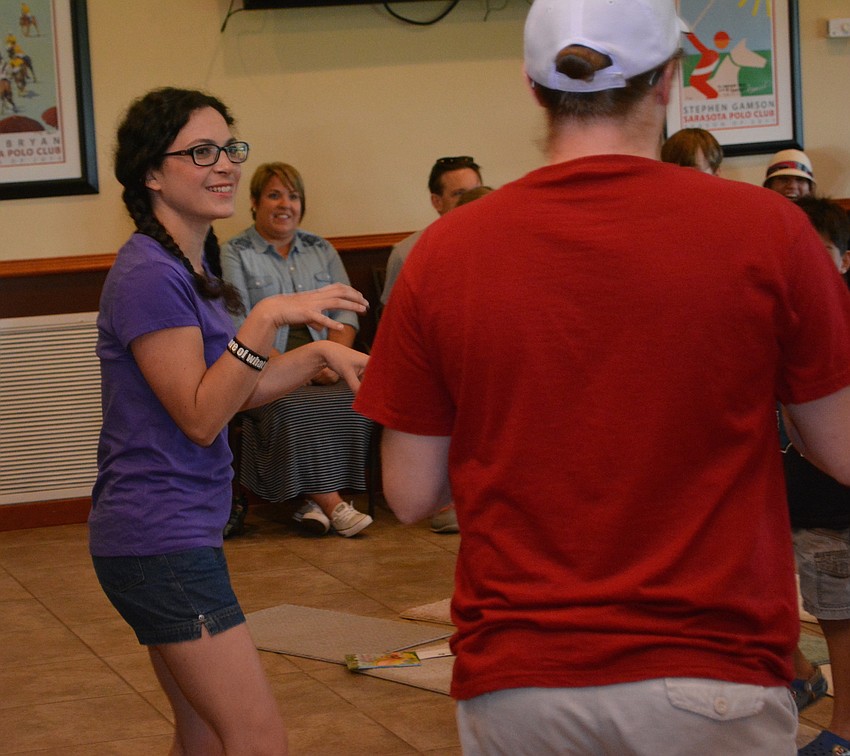 Eliza Engle does a little dinosaur demonstration.
