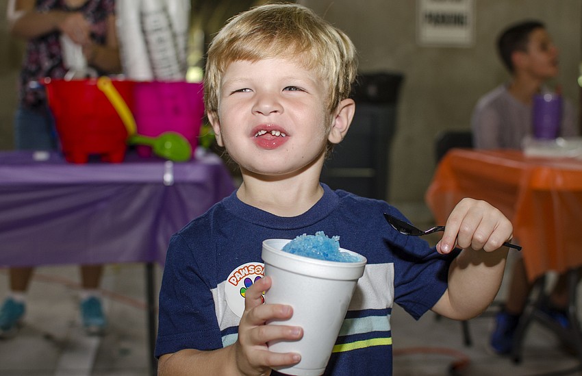 Michael Kern enjoys a snow cone at Doctors Hospital of Sarasota's carnival benefiting the Southeastern Guide Dogs.