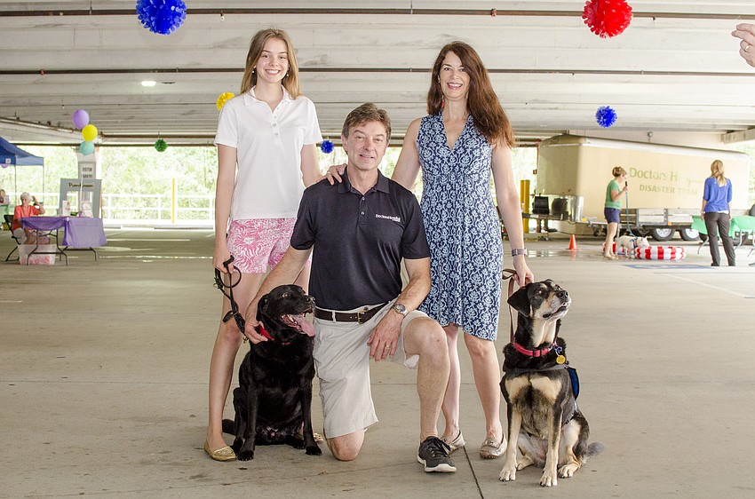 Hannah Meade, Doctors Hospital of Sarasota CEO Bob Meade and Pamela Meade pose at  Doctors Hospital of Sarasota's carnival benefiting the Southeastern Guide Dogs.