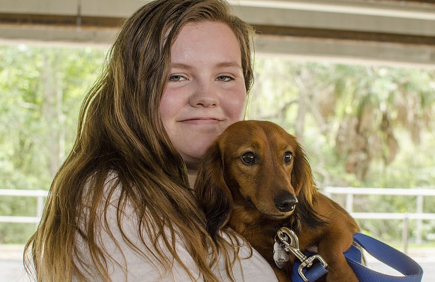 Emma Kirby poses with Zeus during the  Doctors Hospital of Sarasota's carnival benefiting the Southeastern Guide Dogs.