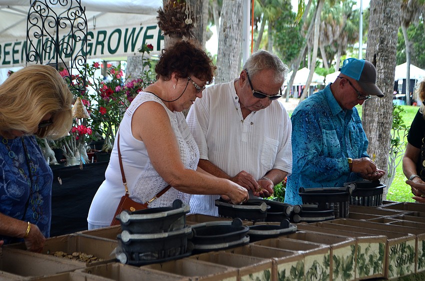 Festival goers sift through stones at the 16th annual St. Armands Circle Craft Festival.
