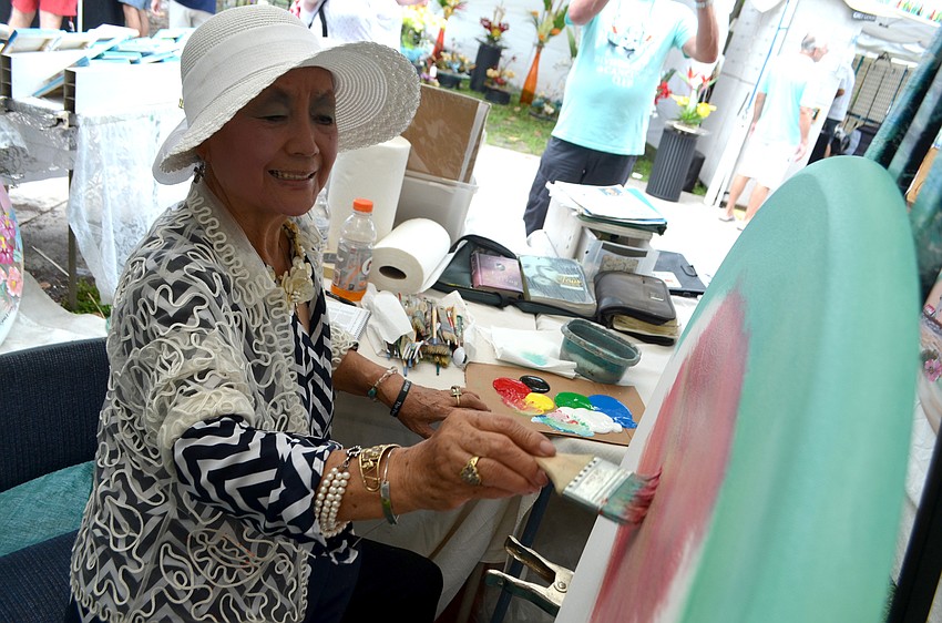 Kyung Ai Park works on a painting during the festival.