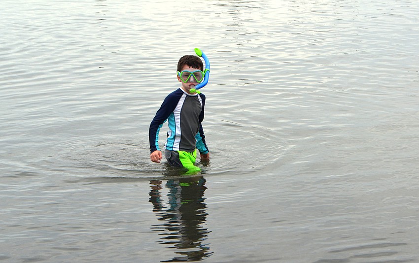 Ryan Dascenzl gets ready to snorkel around the New Pass Inlet.