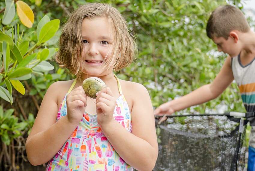 Claire McGettigan shows off a shell she found.