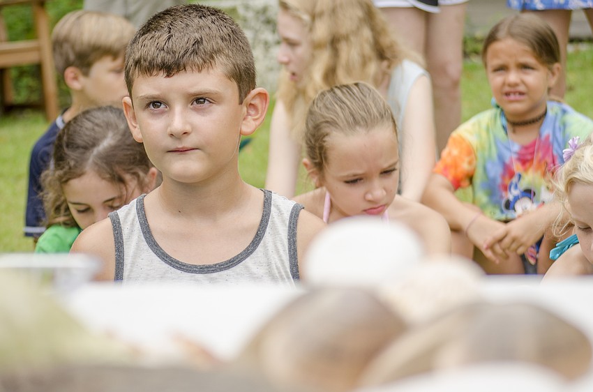 Aiden McGettigan listens to a presentation by Kris Fehlberg of Biotica Ecotours  before campers waded into Sarasota Bay to look for sea life.