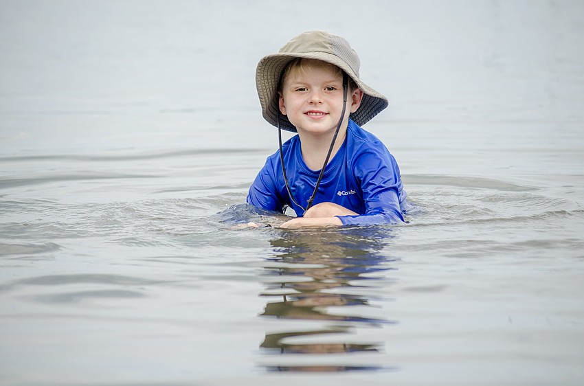 Kyle Gandy searches for sea life during Selby's Camp Lookout.