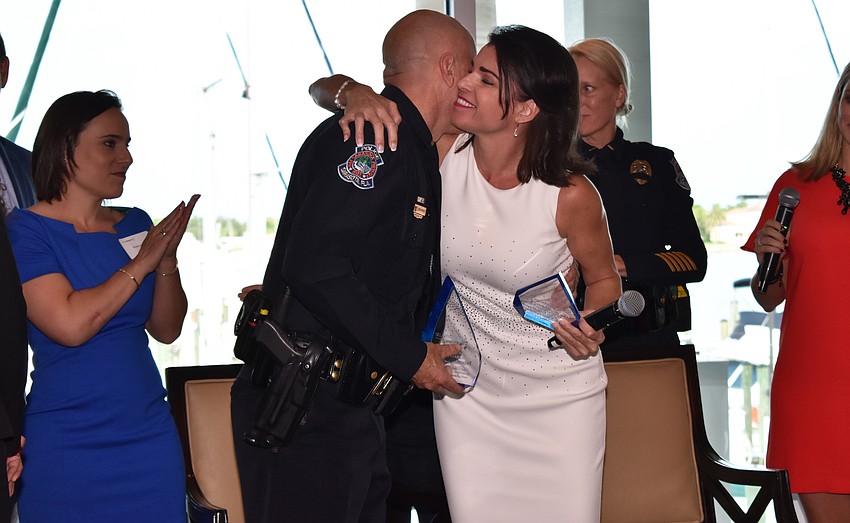 Detective Demetri Konstantopoulos and Selah Freedom President and CEO Elizabeth Fisher embrace on June 15 at Sarasota Yacht Club after Fisher recognized him and the rest of Sarasota Police Department.