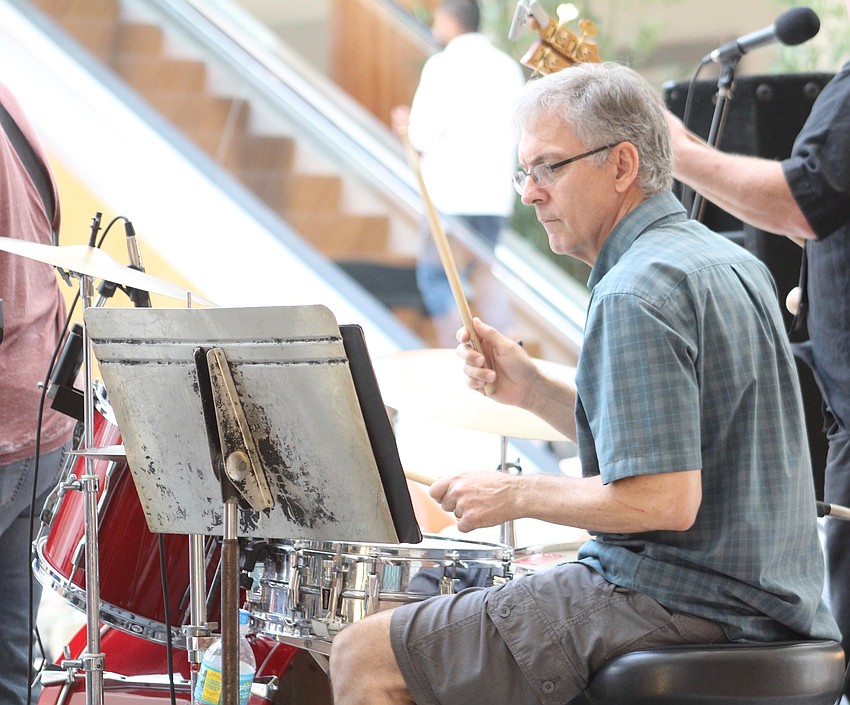 Crystal Blue band drummer Steve Bahnuk jams out at The Mall at University Town Center.