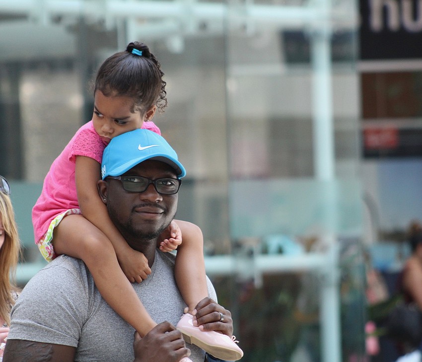 East County's Brooklyn Williams catches a ride on Isaiah Williams' back as they wait in line for food.