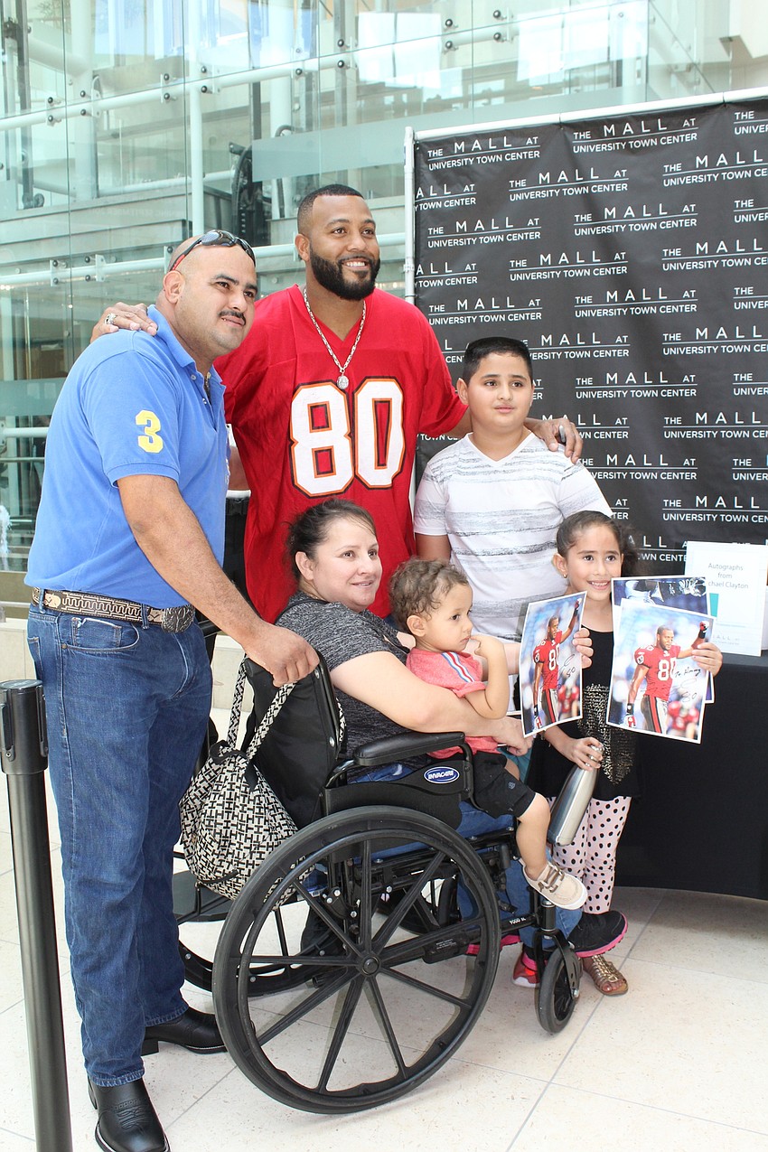 Back: East County's Melvin Arriaza, former Bucs wide receiver Michael Clayton and Jared Arriaza. Front: East County's Estella, Ivan and Ammy Arriaza.