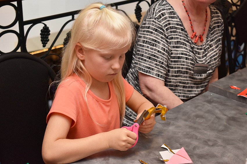 Elizabeth Morris focuses on making a octopus origami bookmark at Asolo Family Day on June 17 at the FSU Center for the Performing Arts.