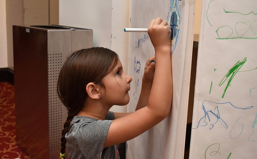Fionna Whatley focuses on a drawing of a sea turtle at Asolo Family Day on June 17 at the FSU Center for the Performing Arts.