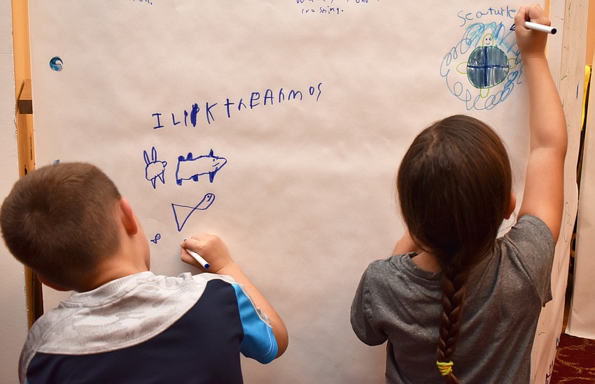 Cayden Parker and Fionna Whatley draw marine life at Asolo Family Day on June 17 at the FSU Center for the Performing Arts.