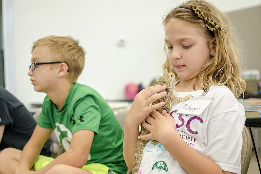 Maggie Layman holds one of the two bearded dragons that were passed between campers.