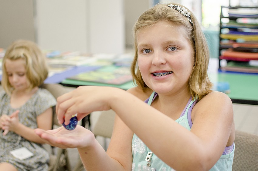 Zoey Bell holds a hermit crab during the Humane Society of Sarasota County's Fur Fun Summer Camp.