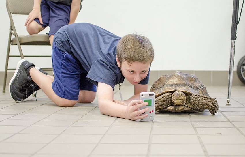 Bobby Dodd takes a selfie with Charlie the tortoise.