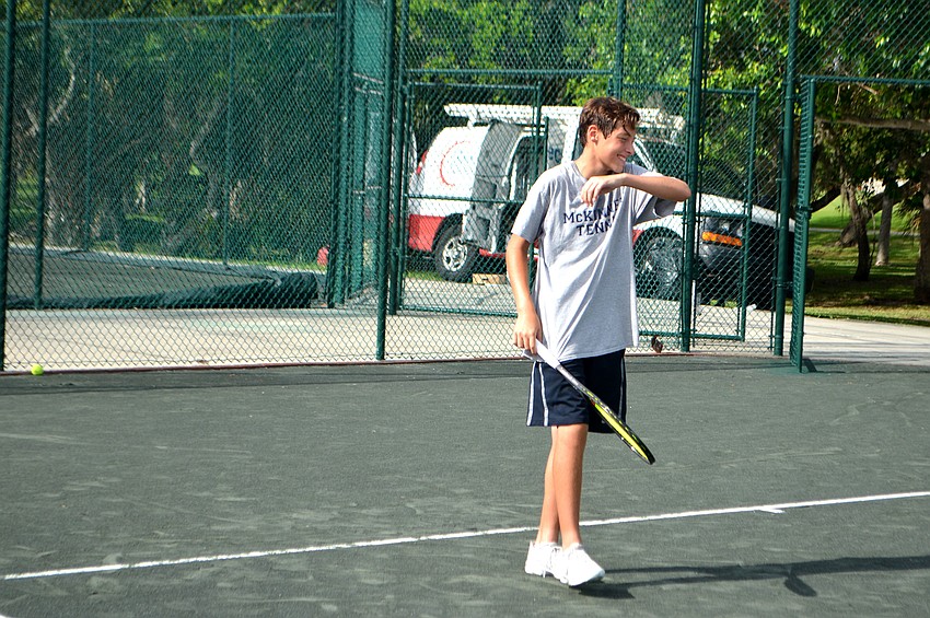 Nathan Moon laughs after serving the ball.