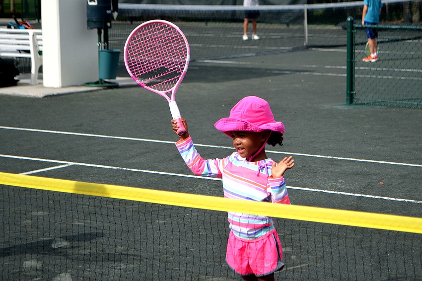 Sofia Grace Harris waits for her turn at tennis camp on June 21.