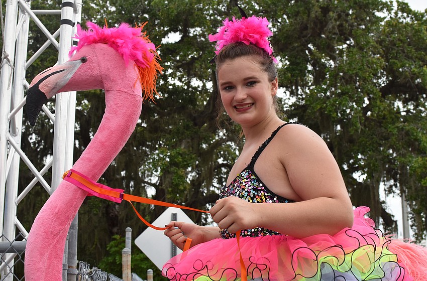 Teagan Allan welcomes guests while walking on stilts.