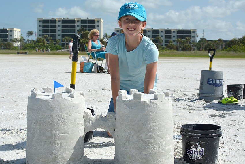 Makena Jenkins poses with her sand castle.
