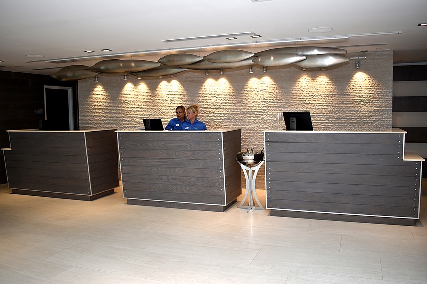 The lobby of Zota Beach resorts is open with high-ceilings. Two couches provide seating for guests.