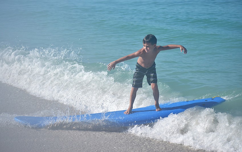 Ethan Helrigle rides a wave into shore.