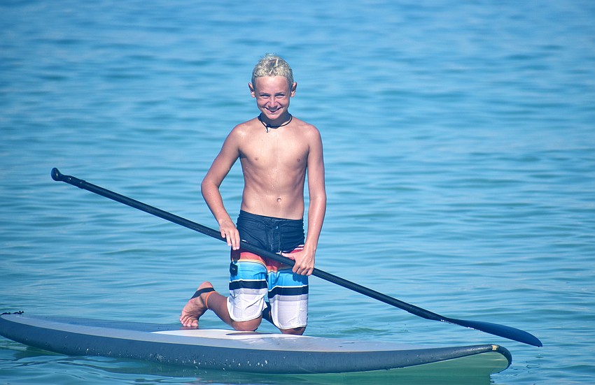 Xander LaBelle is all smiles during Sarasota County’s Skim, Surf and Paddle Camp on June 28.