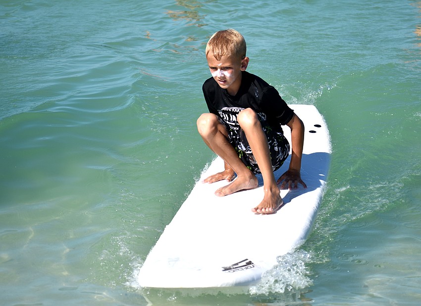 Chase Braune rides a wave during Sarasota County’s Skim, Surf and Paddle Camp on June 28.