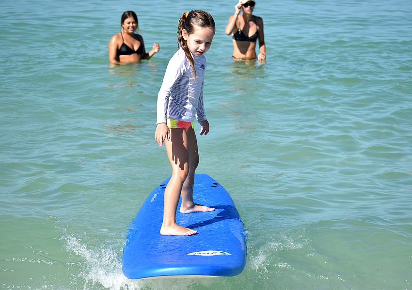 Gigi Tuffile catches a wave during Sarasota County’s Skim, Surf and Paddle Camp on June 28.