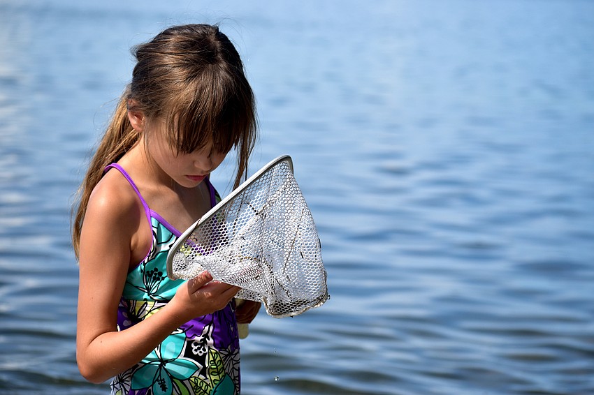 Landry Kidd checks her net for marine life.