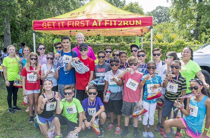 Top-finishers pose with Fit2Run staff after being awarded their medals.