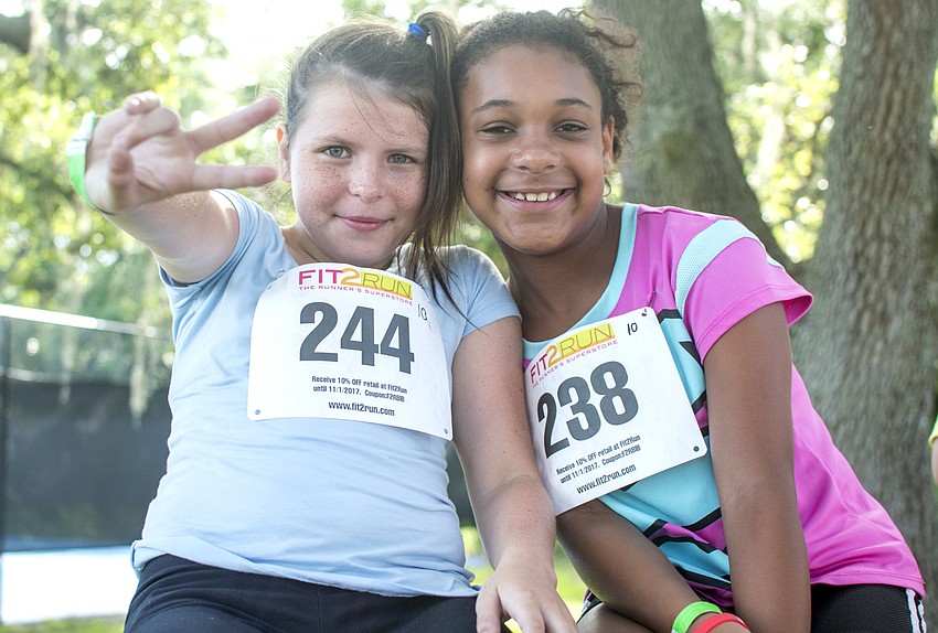 Paisley and Ariyana pose with their racing bibs before the Fit2Run fun run at Boys and Girls club.