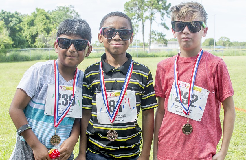 Top-finishers Jeremy, Jakobe and Ethan pose with their medals.