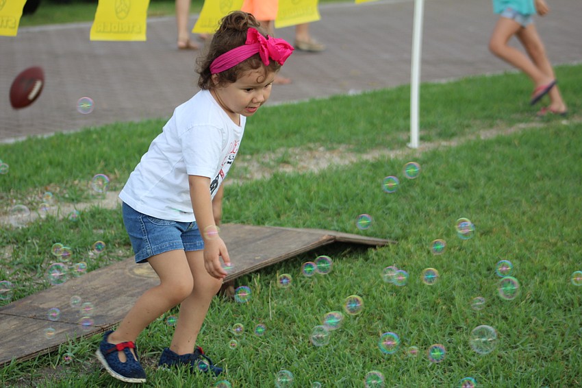 Sarasota's Emma Morales, 3, chases bubbles at Nathan Benderson Park.